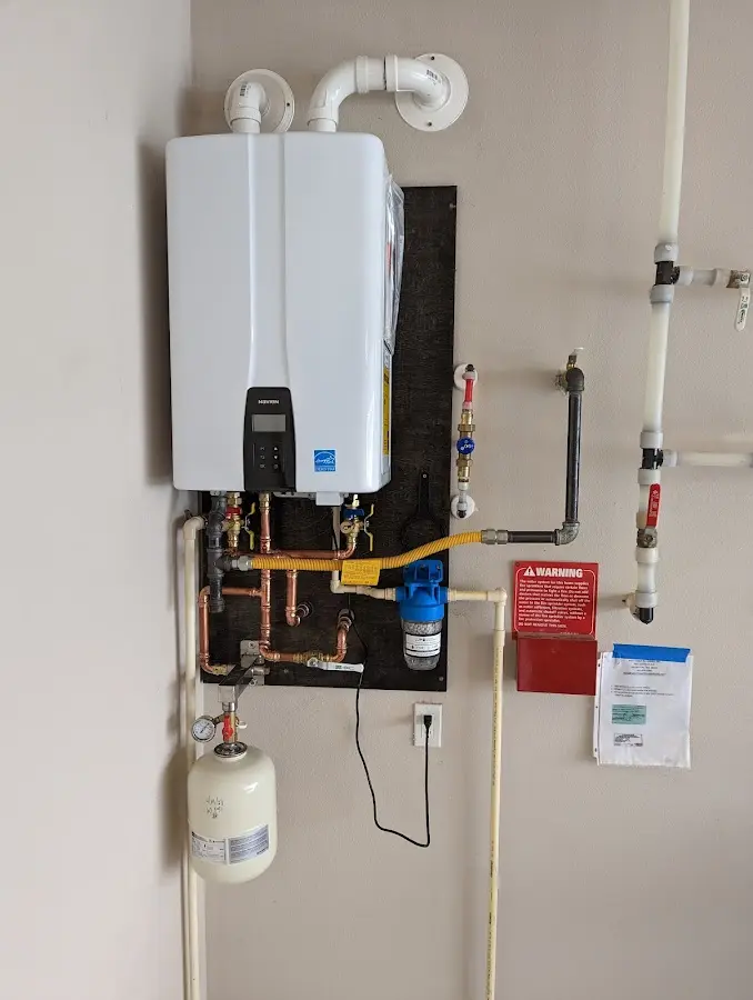 Professional plumber installing copper piping in a Ypsilanti home